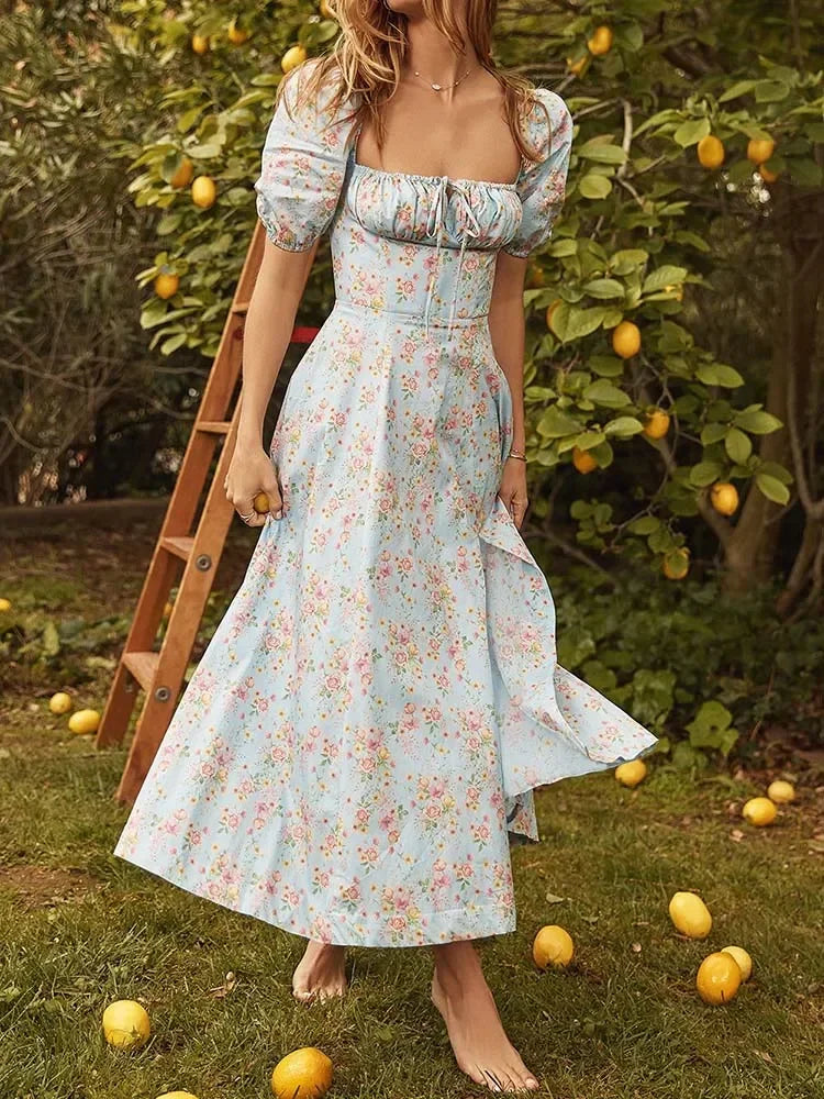 EtherealBe floral print maxi dress with puff sleeves and a flowy skirt, set in a garden with lemons