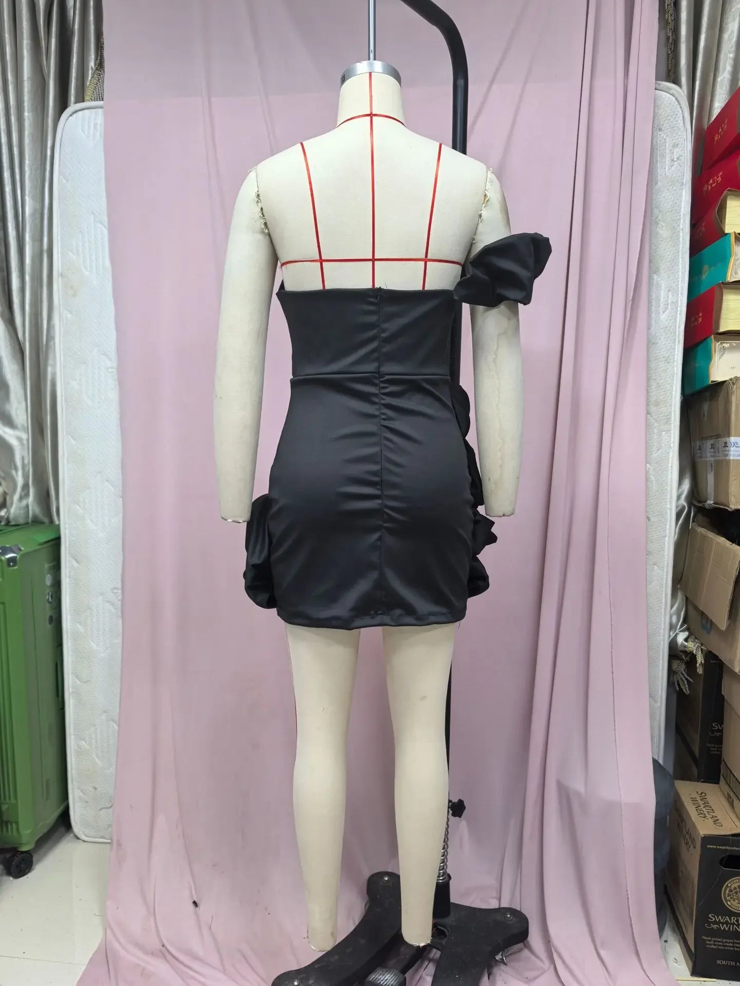 Back view of an EtherealBe formal strapless cocktail dress with a ruffled hem detail in black