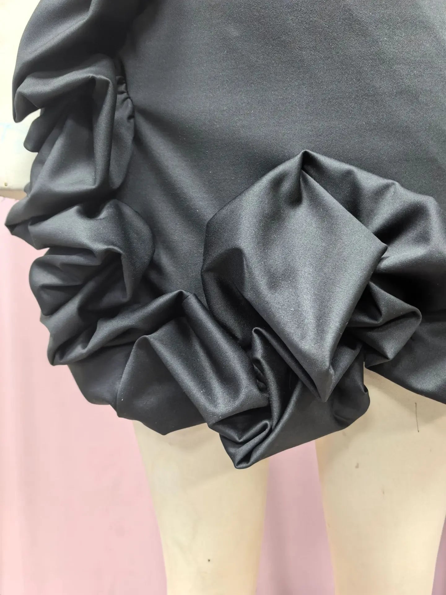 Close-up of ruffled design on an EtherealBe formal strapless cocktail dress in black fabric
