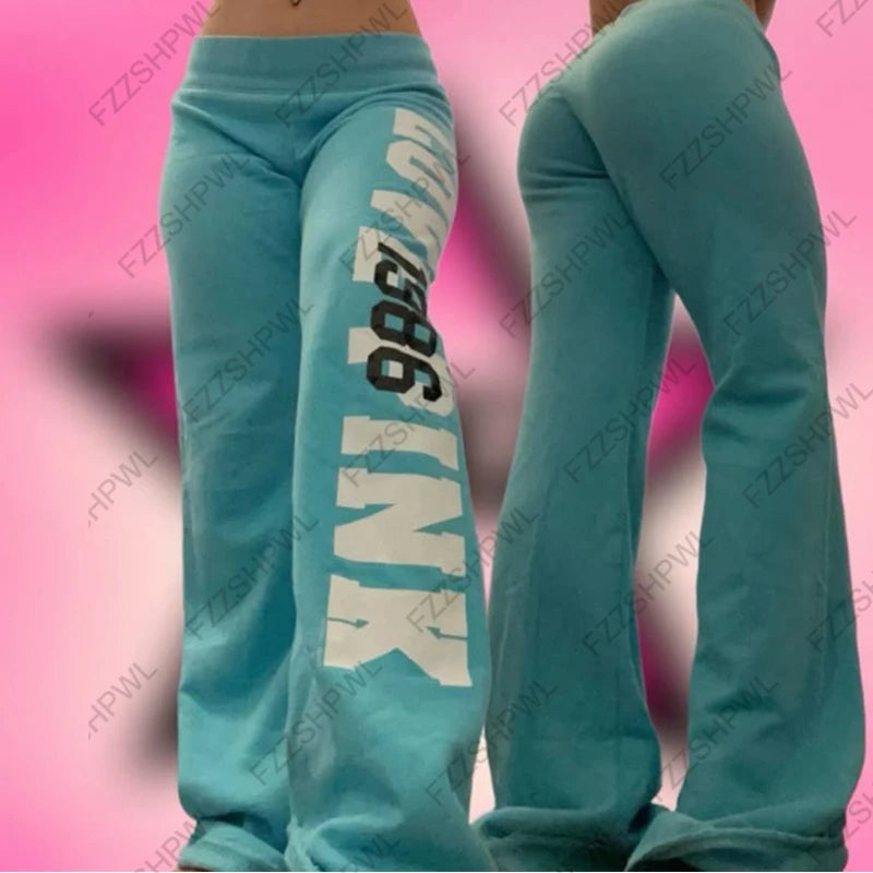 Model wearing teal American vintage flare sweatpants with bold white NY 98 leg print front and back views