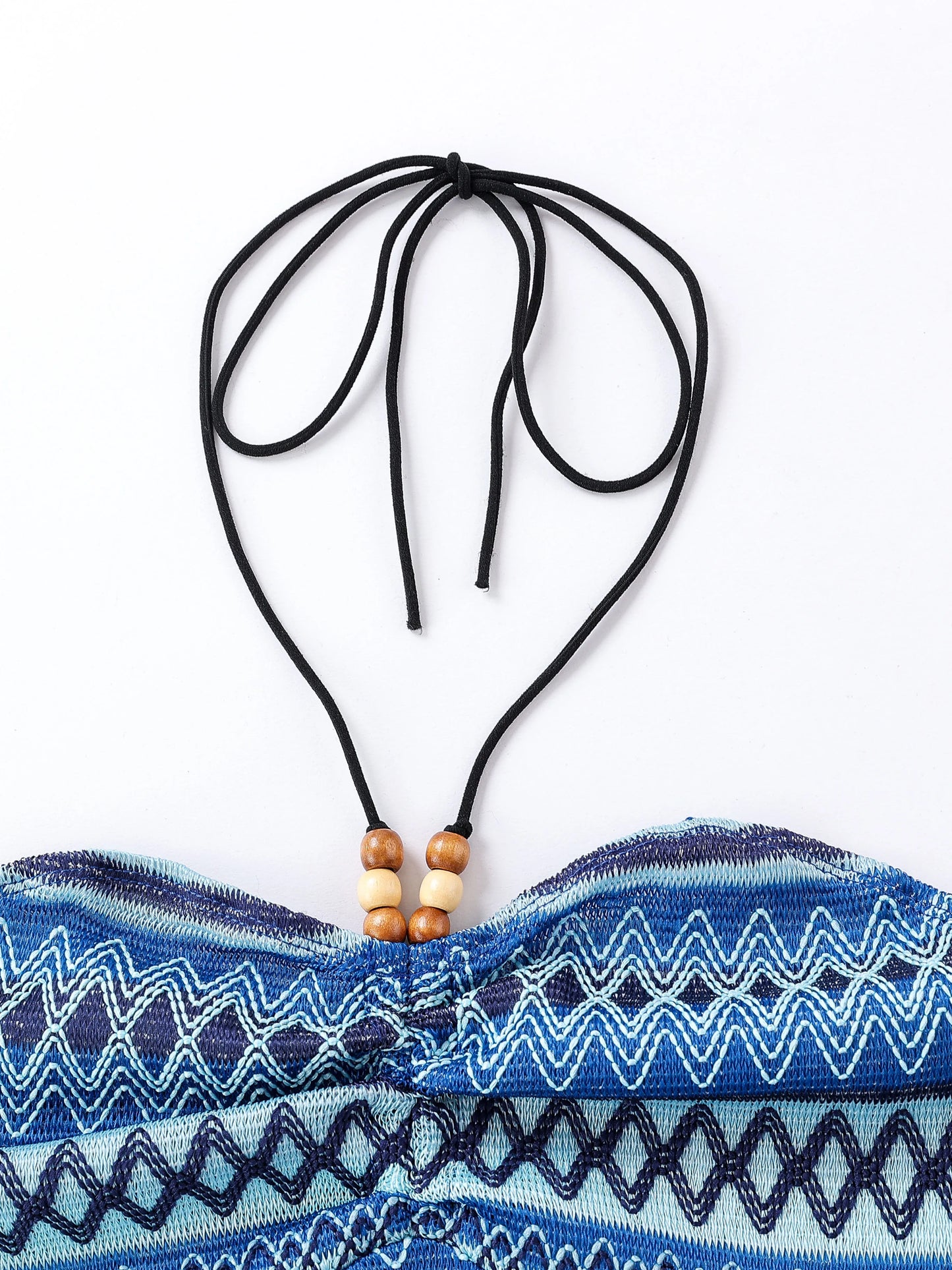Close-up of an EtherealBe geo pattern beaded halter crop top with adjustable ties and colorful patterns