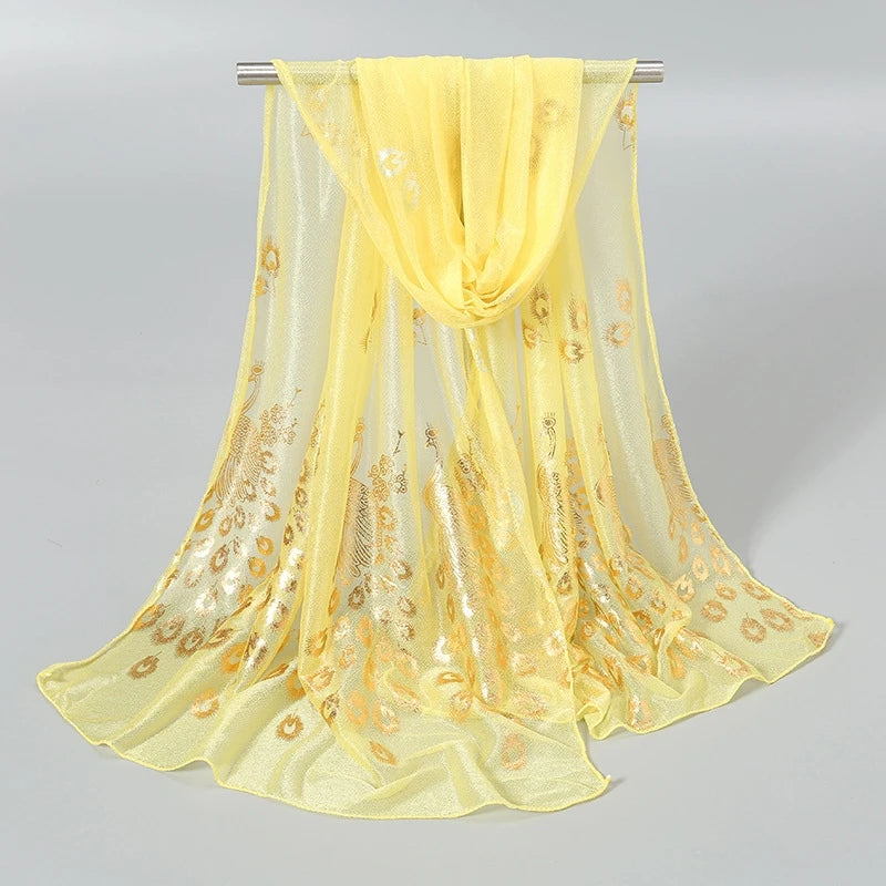 Ethereal gold stamped peacock scarf in soft yellow with elegant floral patterns for stylish accessorizing