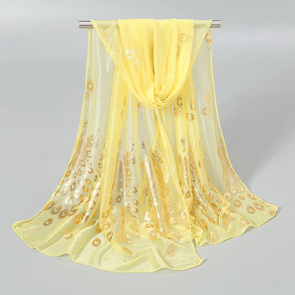 Ethereal gold stamped peacock scarf in soft yellow with elegant floral patterns for stylish accessorizing
