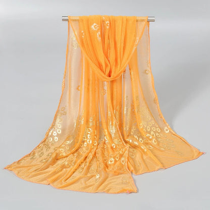 Gold stamped peacock scarf in vibrant orange, featuring intricate designs for a stylish accessory