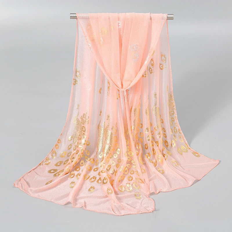 Delicate peach scarf featuring gold stamped peacock design for stylish accessorizing