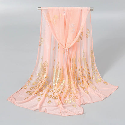 Delicate peach scarf featuring gold stamped peacock design for stylish accessorizing