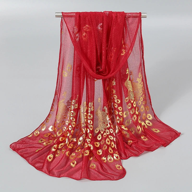 Elegant red scarf with gold stamped peacock design, perfect for adding a luxurious touch to any outfit.