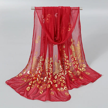 Elegant red scarf with gold stamped peacock design, perfect for adding a luxurious touch to any outfit.
