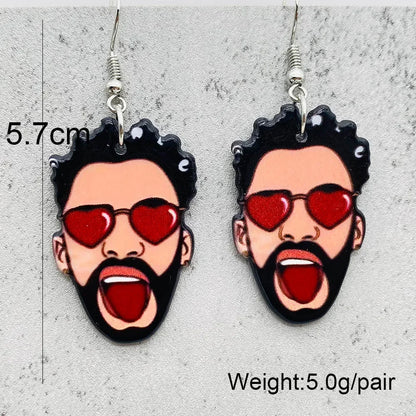 Unique Halloween horror earrings featuring a cartoon face with red sunglasses and a shocked expression