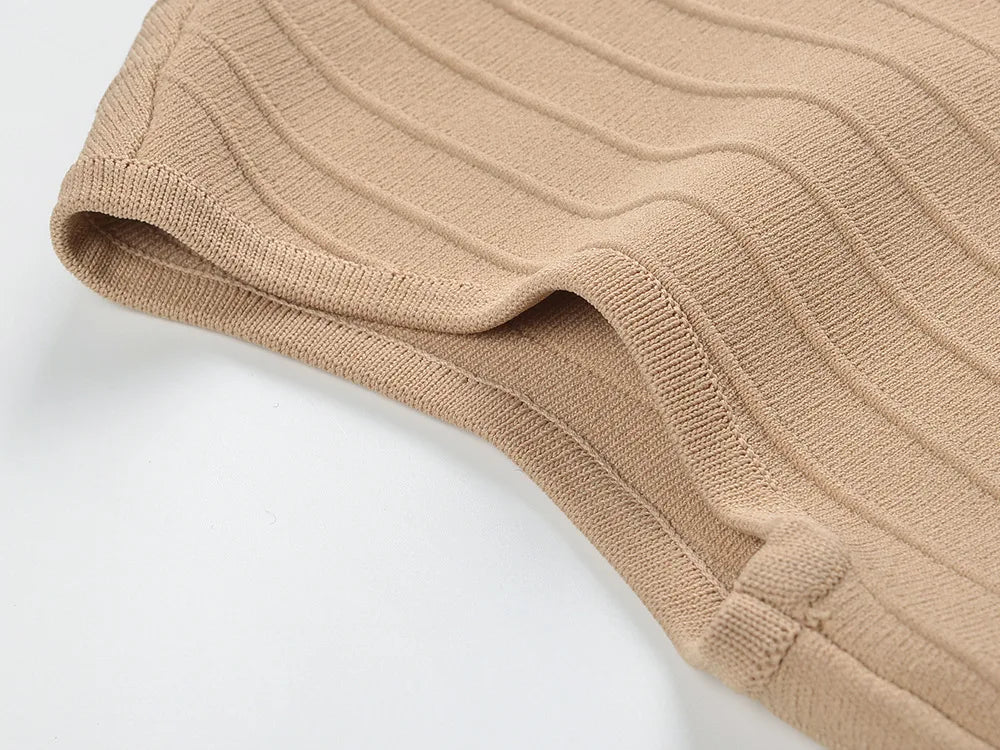 Close-up of the fabric texture of a V-neck sleeveless fall dress for women in beige color