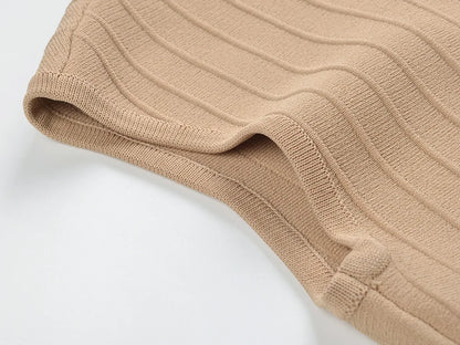 Close-up of the fabric texture of a V-neck sleeveless fall dress for women in beige color