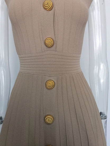 Close-up of a beige V-neck sleeveless fall dress for women featuring decorative buttons and ribbed texture