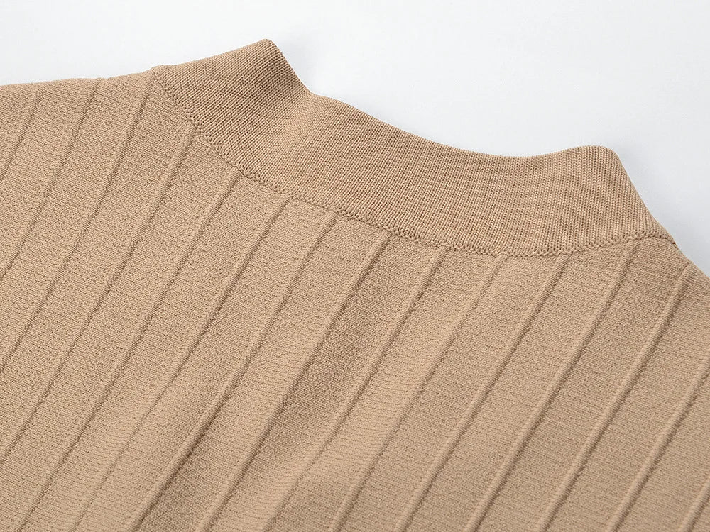 Close-up of the neckline detail on a V-neck sleeveless fall dress for women in a beige ribbed fabric