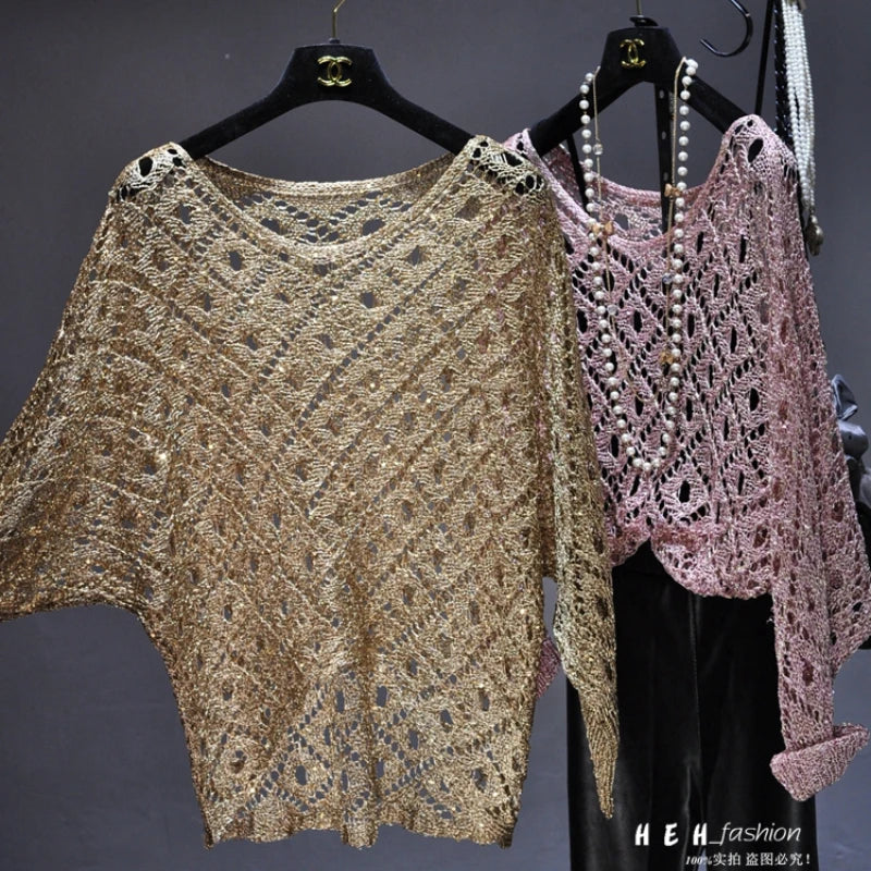 Two crochet sequin tunic tops in gold and pink hung with pearl necklace shown as fall sequin dresses for women display