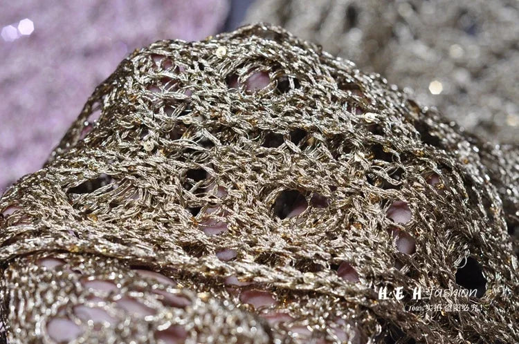 Close up of gold metallic openwork sequin fabric showing texture and shimmer for fall sequin dresses for women