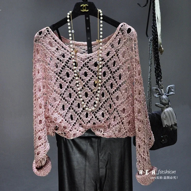 Styling inspiration for fall sequin dresses for women pink crochet openwork sweater over black leather pants with pearl necklace