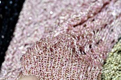 Close up of pink metallic sequin knit fabric swatch showcasing shimmer texture for fall sequin dresses for women
