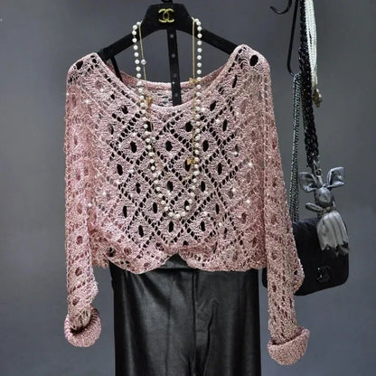 Light pink open knit crochet sweater with pearl necklace over black leather pants styled outfit fall sequin dresses for women