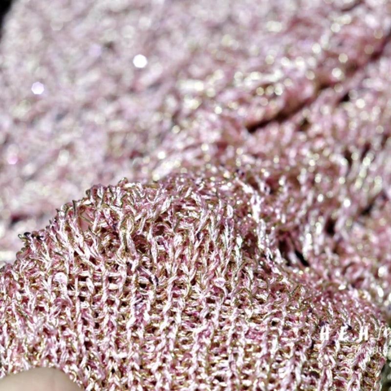 EtherealBe pink metallic knit sequin fabric close up highlighting texture and sparkle for fall sequin dresses for women