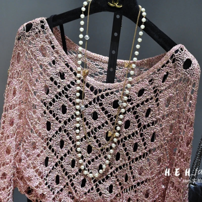 Styling display for fall sequin dresses for women featuring pink crochet openwork top with layered pearl necklace on hanger