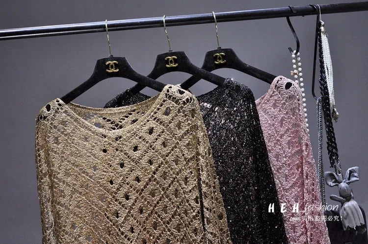 EtherealBe fall sequin dresses for women in gold black and blush pink lace knit hanging on a rack with pearl necklace