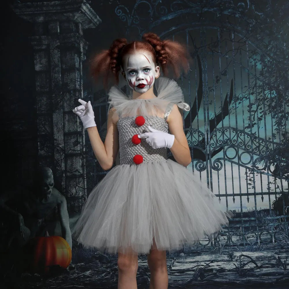 Girls wearing kids creepy clown Halloween costume with gray tutu and red pom-poms for spooky celebrations