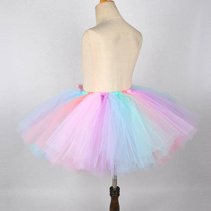 Colorful kids unicorn Halloween costume with wings featuring a fluffy tulle skirt in pastel shades