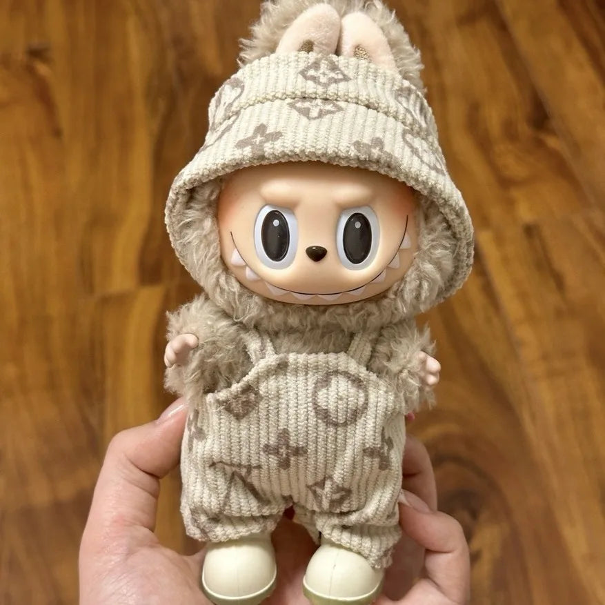 Adorable Labubu doll clothes featuring a plush beige outfit with a cute hood and pockets