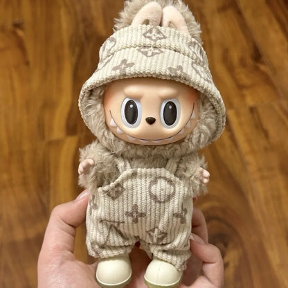 Adorable Labubu doll clothes featuring a plush beige outfit with a cute hood and pockets