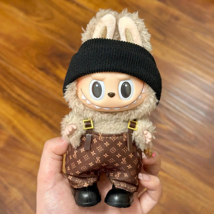 Cute Labubu doll clothes featuring stylish brown overalls and a black beanie for trendy dolls