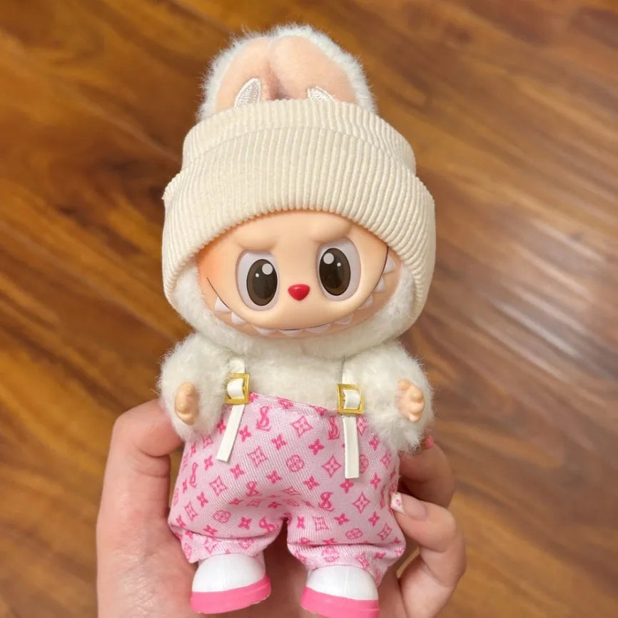 Adorable Labubu doll clothes featuring a fluffy outfit and trendy accessories for fashion-forward dolls