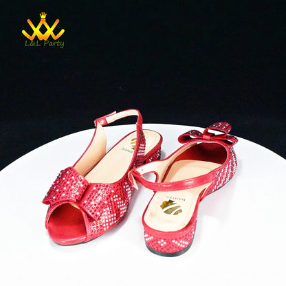 Red sequined peep toe slingback flats with bow detail on white pedestal by EtherealBe Fashionable shoes and bag set.