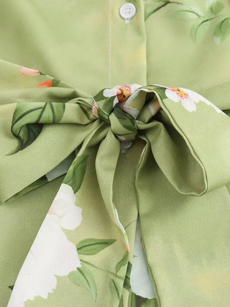 Detail of long sleeve spring floral midi dress highlighting tied bow and floral pattern