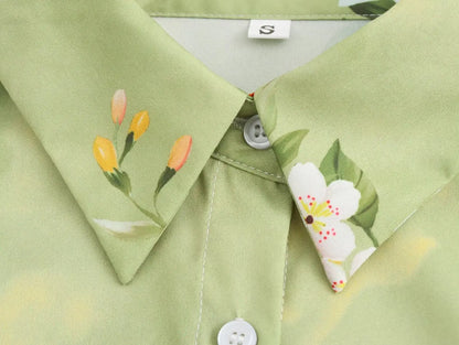 Close-up of long sleeve spring floral midi dress collar featuring delicate floral patterns and soft green fabric