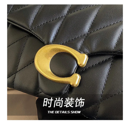 Black quilted leather luxury square chain handbag with gold C clasp detail and flap closure close up