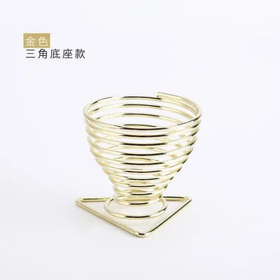 Elegant gold makeup sponge holder designed in a spiral shape for stylish organization