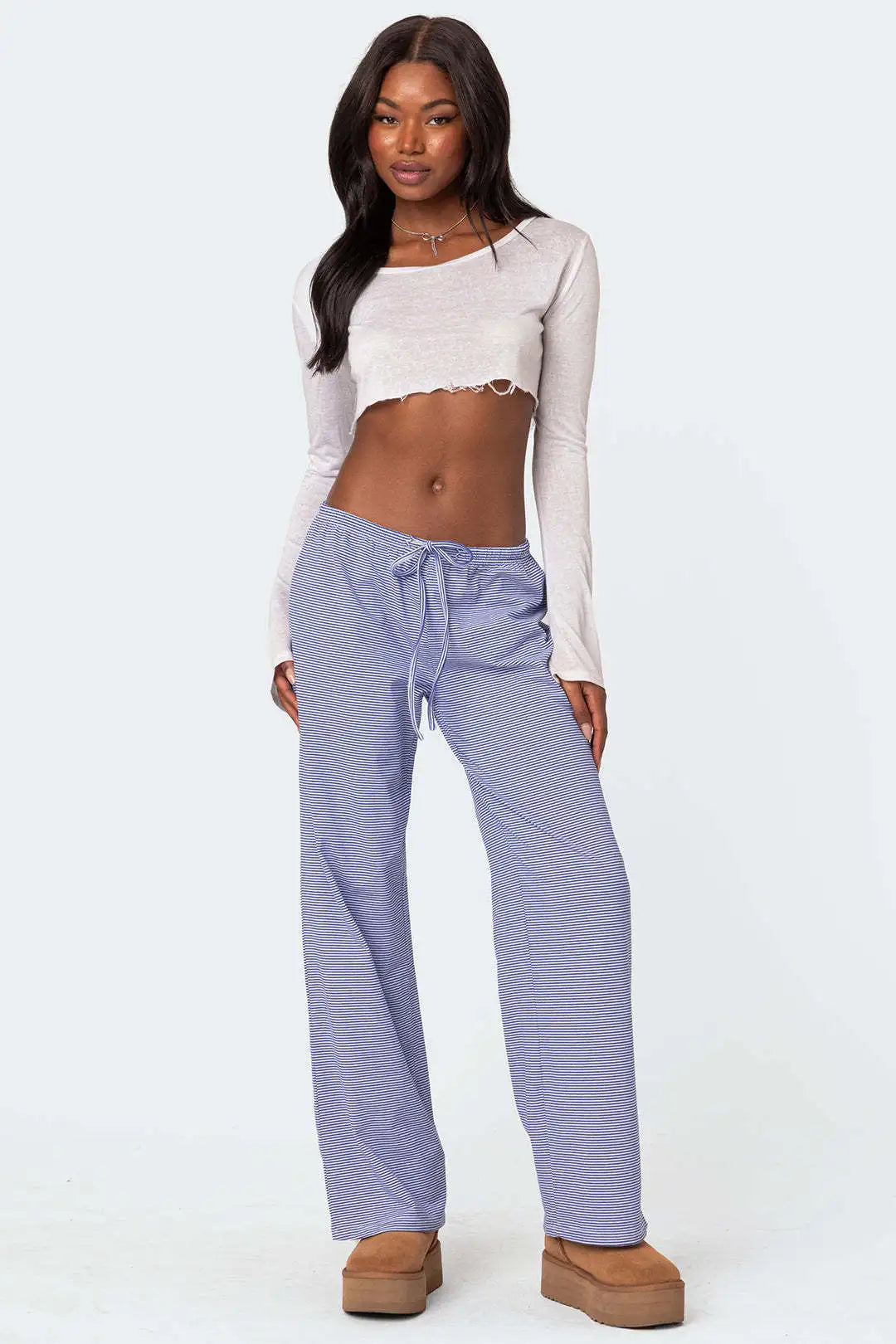 Chic model wearing light blue milk silk casual pants for women with a drawstring waist