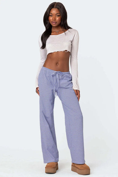 Chic model wearing light blue milk silk casual pants for women with a drawstring waist