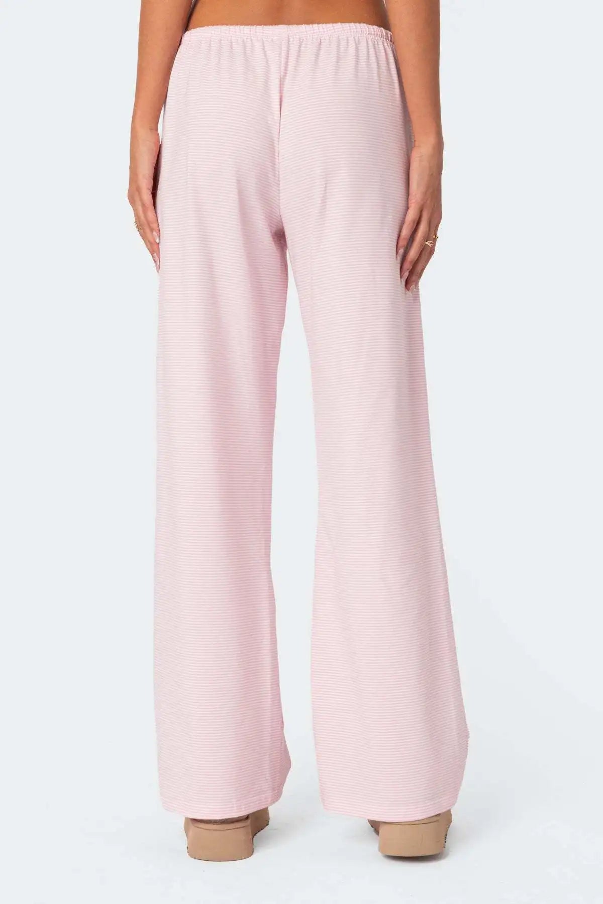 Back view of EtherealBe milk silk casual pants for women in light pink with a relaxed fit