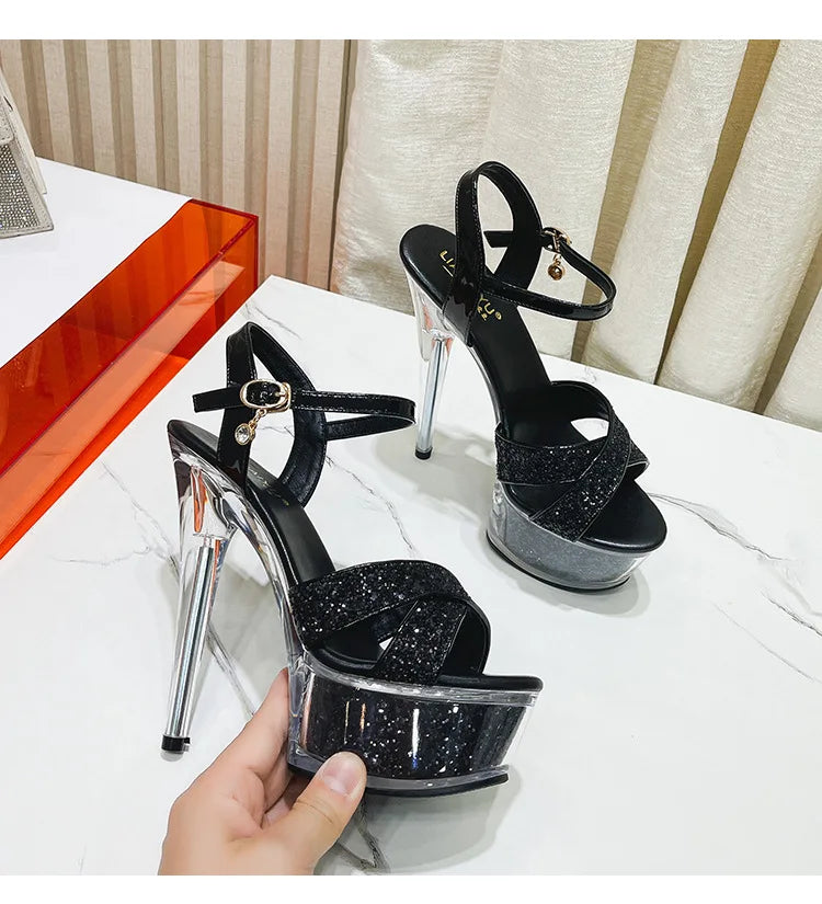 EtherealBe narrow band buckle strapped high heel stilettos with shiny black finish and transparent heel
