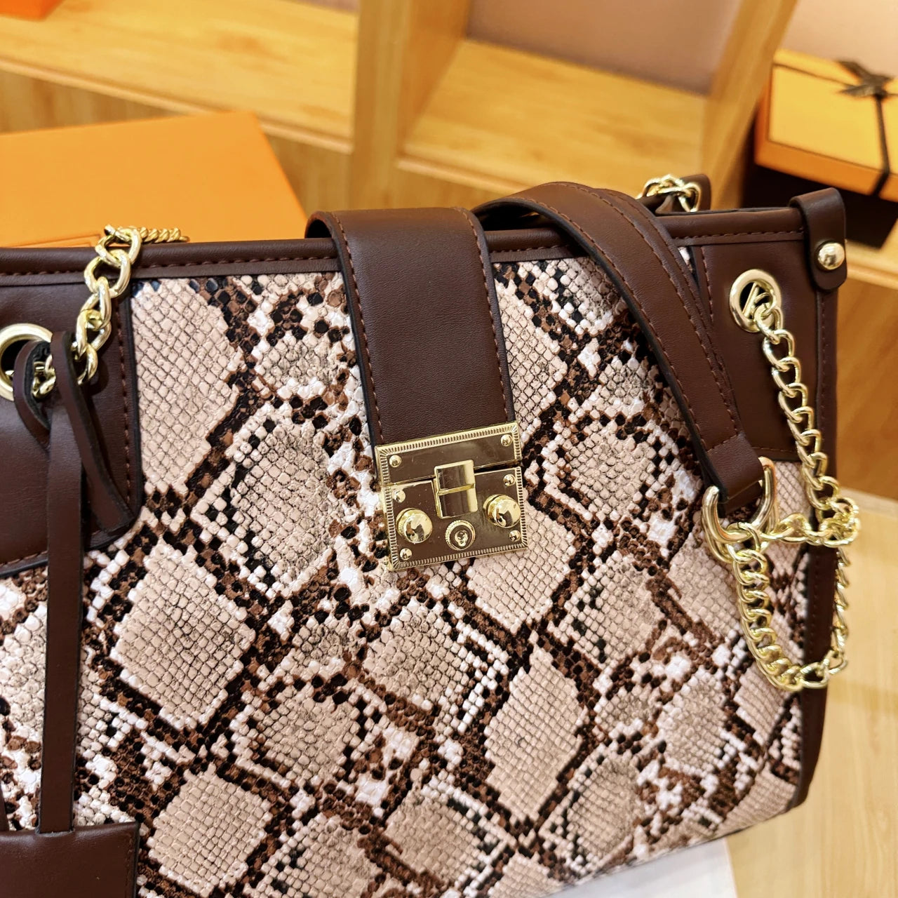 EtherealBe snake print leather shoulder bag with a stylish chain and detailed texture
