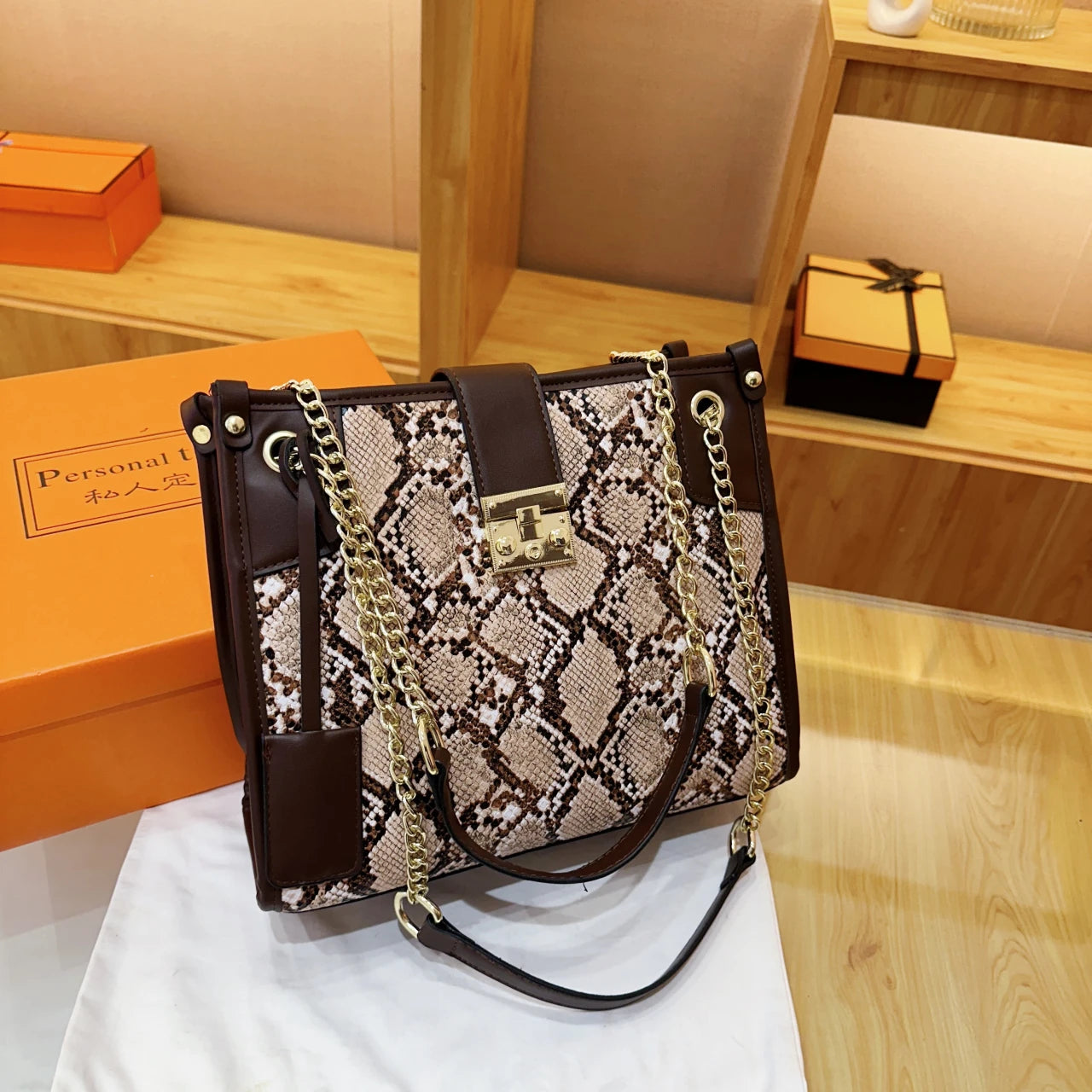 EtherealBe snake print leather shoulder bag with elegant chain straps and stylish design