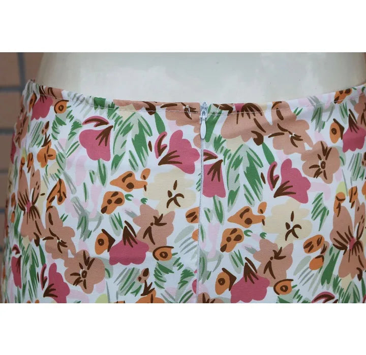 Close-up of EtherealBe pleated ruffle edge dress set featuring a floral pattern in pastel colors