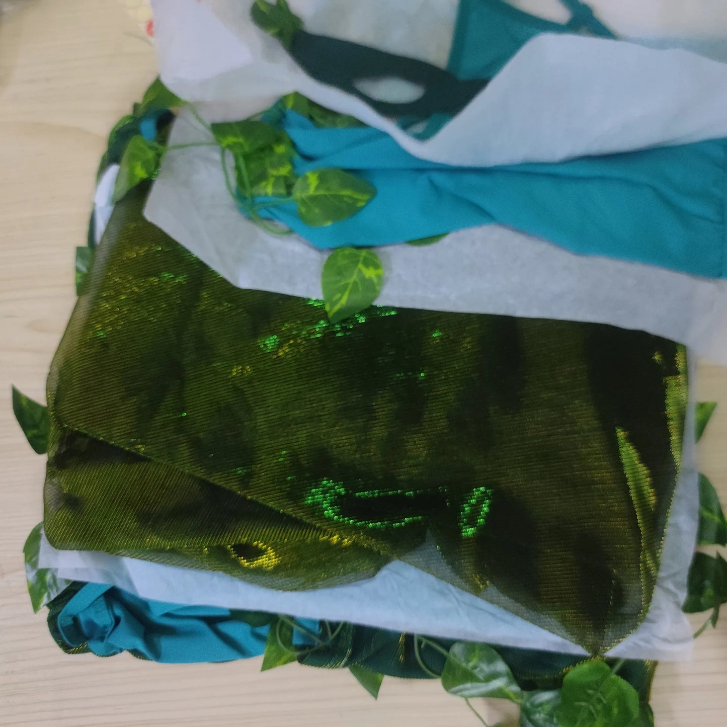 Layered green fabric and leaves for a poison ivy costume for women, perfect for costume parties