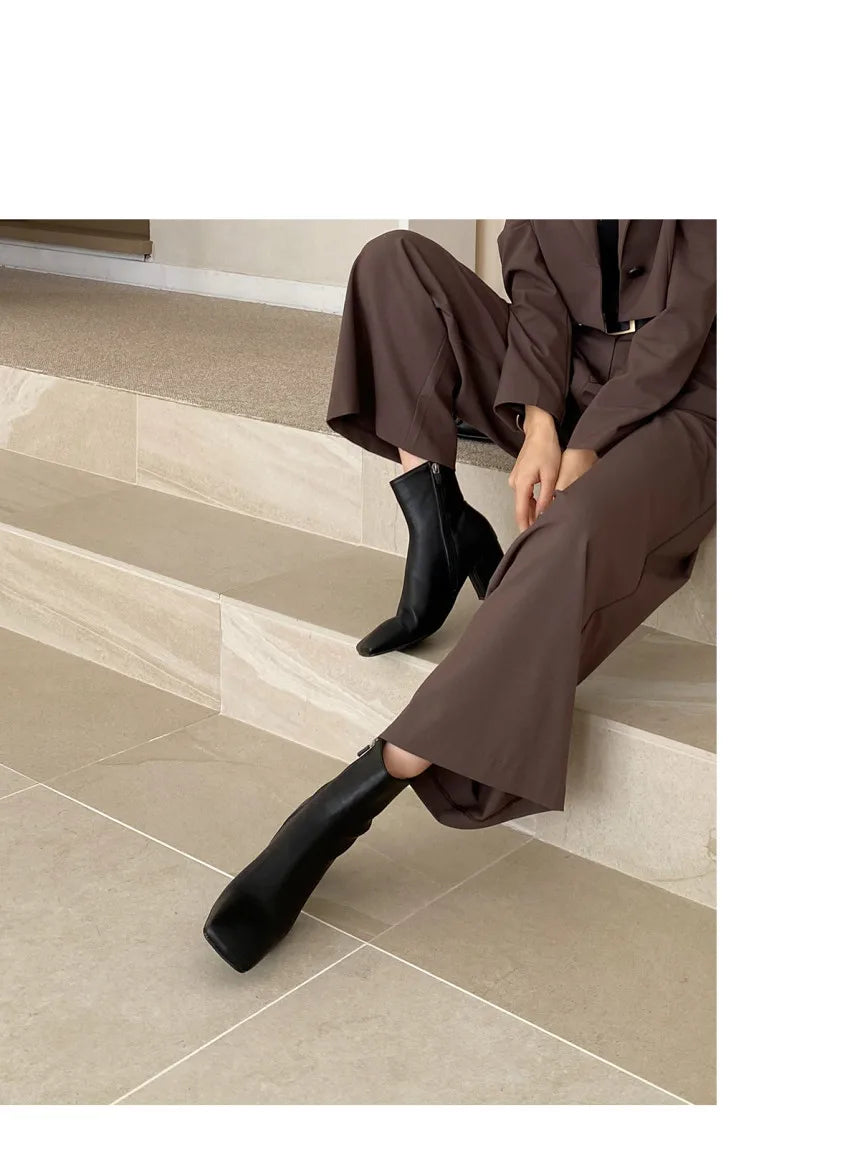 Stylish brown trousers with black ankle boots, perfect for professional corporate attire for women