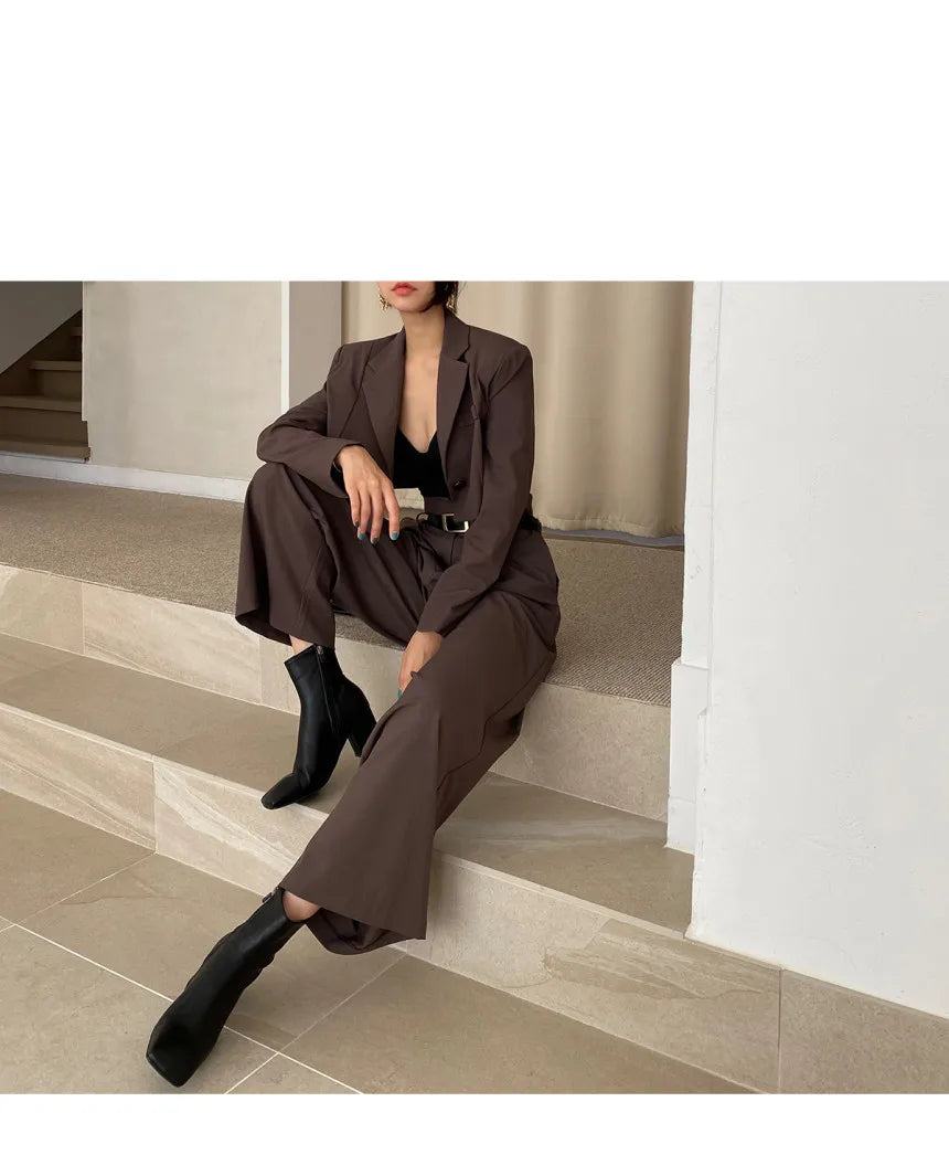 EtherealBe professional corporate attire for women featuring a stylish brown suit and ankle boots