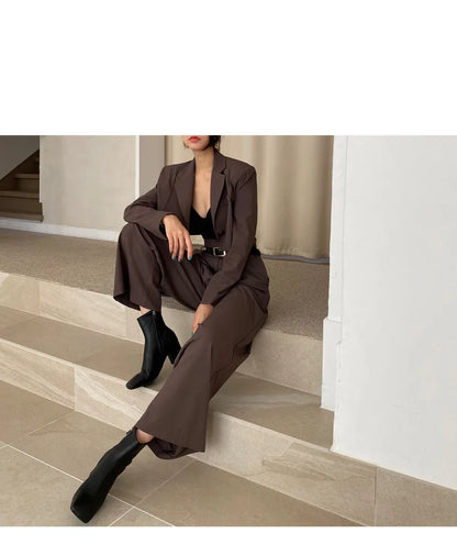 EtherealBe professional corporate attire for women featuring a stylish brown suit and ankle boots