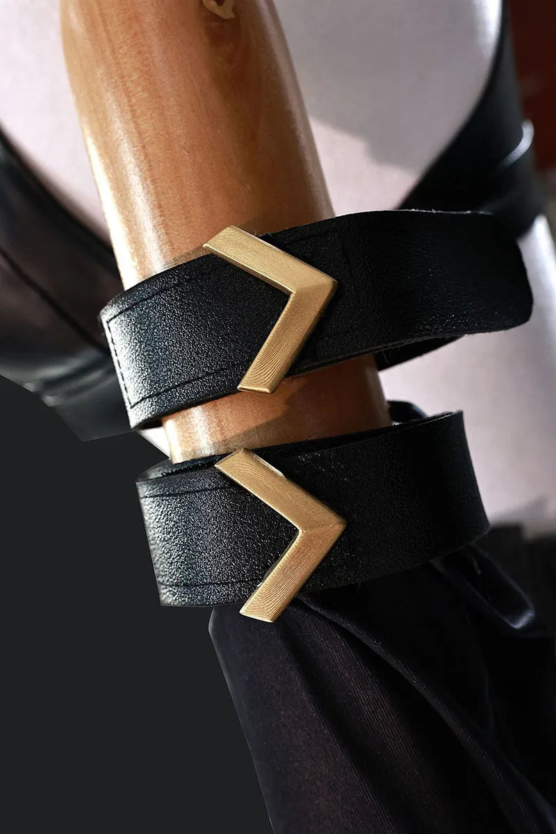 Close-up of black wrist cuffs with gold accents from the Arcane Jinx cosplay costume