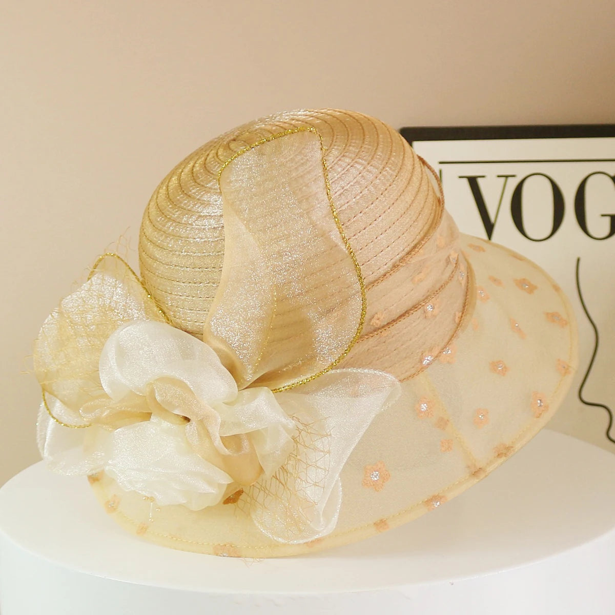 EtherealBe retro wide brim floral hat in gold with decorative bow and sheer fabric for stylish sun protection