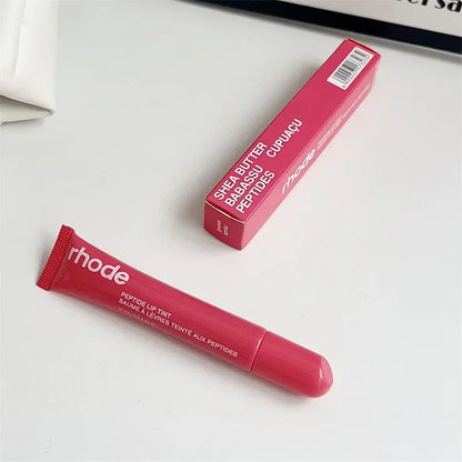 EtherealBe pink peptide lip tint tube and box on white surface Flavored moisturizing lip balm for dry lips.